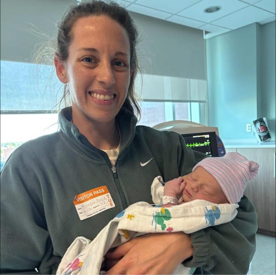 The Missing Peace doula holding a newborn in the hospital